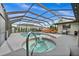 Inviting screened pool and spa with lounge chairs at 10194 Thames Ave, Englewood, FL 34224