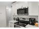 Modern kitchen with stainless steel appliances and white cabinets at 10194 Thames Ave, Englewood, FL 34224