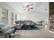 Spacious living room featuring a comfortable sectional sofa and a ceiling fan at 10194 Thames Ave, Englewood, FL 34224