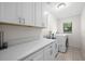 Laundry room with white cabinets, countertop, and washer/dryer at 10194 Thames Ave, Englewood, FL 34224