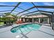 Relaxing pool area with a covered patio and lounge chairs at 10194 Thames Ave, Englewood, FL 34224