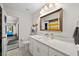 Clean bathroom with white vanity and a large mirror at 10194 Thames Ave, Englewood, FL 34224