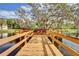 Wooden dock extending over calm water, surrounded by trees at 236 Hidden Bay Dr # 301, Osprey, FL 34229