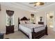 Spacious bedroom with a queen-size bed and ensuite bathroom access at 11358 Lomita Wren Rd, Weeki Wachee, FL 34614