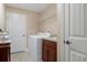 Well-appointed laundry room with washer, dryer, and utility sink at 11358 Lomita Wren Rd, Weeki Wachee, FL 34614