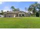 Single-story home with a well-manicured lawn at 11358 Lomita Wren Rd, Weeki Wachee, FL 34614