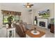 Spacious living room with a fireplace and large TV at 11358 Lomita Wren Rd, Weeki Wachee, FL 34614