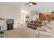 Relaxing living room with leather furniture and access to kitchen at 11358 Lomita Wren Rd, Weeki Wachee, FL 34614