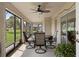 Relaxing screened porch with seating area, ceiling fan, and views of the backyard at 11358 Lomita Wren Rd, Weeki Wachee, FL 34614