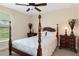 Serene bedroom with a four-poster bed and nightstands at 11358 Lomita Wren Rd, Weeki Wachee, FL 34614