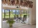 Relaxing screened porch with table and chairs, overlooking backyard at 11358 Lomita Wren Rd, Weeki Wachee, FL 34614
