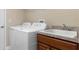 Laundry room features a washer, dryer, and built-in cabinets at 11358 Lomita Wren Rd, Weeki Wachee, FL 34614