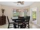 Bright dining area with a table and chairs by the window at 11358 Lomita Wren Rd, Weeki Wachee, FL 34614