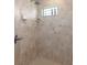 Large walk-in shower with neutral tile and built-in shelving at 11358 Lomita Wren Rd, Weeki Wachee, FL 34614