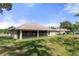 Charming single-story house with a screened porch and a well-maintained lawn at 11358 Lomita Wren Rd, Weeki Wachee, FL 34614