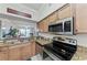 Kitchen features stainless steel appliances and granite countertops at 6519 Grand Estuary Trl # 205, Bradenton, FL 34212