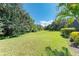 Spacious backyard with lush green lawn and mature trees at 11770 Hidden Forest Loop, Parrish, FL 34219