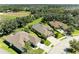 Aerial view of three homes, showcasing curb appeal at 11770 Hidden Forest Loop, Parrish, FL 34219