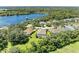 Aerial view of the house and surrounding neighborhood, showcasing a lake at 11770 Hidden Forest Loop, Parrish, FL 34219