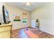 Bedroom with wood floors, TV, and exercise mat at 11770 Hidden Forest Loop, Parrish, FL 34219