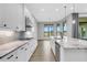 Modern kitchen with white cabinets, granite countertops, and stainless steel appliances at 9004 Artisan Way, Sarasota, FL 34240