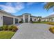 Modern home with three-car garage and landscaping at 9004 Artisan Way, Sarasota, FL 34240
