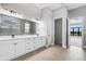 Spa-like bathroom with double vanity, walk-in shower, and views to backyard at 9004 Artisan Way, Sarasota, FL 34240