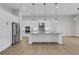 Island kitchen with white cabinets, granite countertops, and stainless steel appliances at 9004 Artisan Way, Sarasota, FL 34240