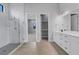 Bright bathroom with double vanity, walk-in shower, and adjacent closet at 9004 Artisan Way, Sarasota, FL 34240