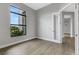 Modern office with hardwood floors and large window at 9004 Artisan Way, Sarasota, FL 34240