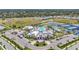 Overhead view of a community clubhouse with a pool, surrounded by lush landscaping at 14480 Eagle Branch Dr, Nokomis, FL 34275