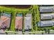 Aerial view of homes with private pools nestled amidst lush landscaping and a serene pond at 14480 Eagle Branch Dr, Nokomis, FL 34275