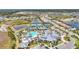 Aerial view of resort-style community amenities including a pool, tennis courts and clubhouse at 14480 Eagle Branch Dr, Nokomis, FL 34275