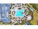 Stunning bird's eye view of community pool with cabanas, lounge areas, and lush greenery at 14480 Eagle Branch Dr, Nokomis, FL 34275