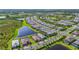 Expansive aerial shot showcasing a community with lush green spaces and tranquil ponds at 14480 Eagle Branch Dr, Nokomis, FL 34275