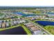 Beautiful aerial view of a community featuring homes with pools and scenic ponds at 14480 Eagle Branch Dr, Nokomis, FL 34275