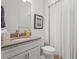 Cozy bathroom featuring granite countertop vanity and shower with curtain at 14480 Eagle Branch Dr, Nokomis, FL 34275