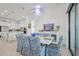 Chic dining room with a modern chandelier and zebra print chairs. Open to kitchen and living area at 14480 Eagle Branch Dr, Nokomis, FL 34275