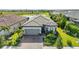 Charming single-story home with a well-manicured lawn, brick driveway, and inviting curb appeal at 14480 Eagle Branch Dr, Nokomis, FL 34275
