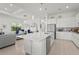 Open concept kitchen features an island with bar seating and a view into the adjacent living area at 14480 Eagle Branch Dr, Nokomis, FL 34275