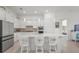 Modern kitchen with a large island, stainless steel appliances, and abundant white cabinetry at 14480 Eagle Branch Dr, Nokomis, FL 34275