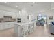 Bright, modern kitchen featuring a large island with seating, stainless steel appliances, and stylish pendant lighting at 14480 Eagle Branch Dr, Nokomis, FL 34275
