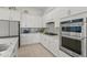 This modern kitchen features sleek stainless steel appliances and bright white cabinetry at 14480 Eagle Branch Dr, Nokomis, FL 34275