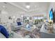 Open-concept living area with modern furniture and access to outdoor living spaces at 14480 Eagle Branch Dr, Nokomis, FL 34275