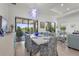 Open-concept living and dining area with floor to ceiling sliders showcasing a view of the lanai at 14480 Eagle Branch Dr, Nokomis, FL 34275