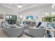Comfortable living room with stylish furnishings, a decorative rug, and sliding glass doors at 14480 Eagle Branch Dr, Nokomis, FL 34275