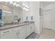 Bathroom featuring double sinks, a granite countertop, and a spacious walk-in shower at 14480 Eagle Branch Dr, Nokomis, FL 34275