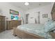 Main bedroom featuring a bed, dressers, and serene atmosphere, perfect for relaxation at 14480 Eagle Branch Dr, Nokomis, FL 34275