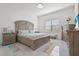 Comfortable main bedroom with a large window for natural light and light wood furniture at 14480 Eagle Branch Dr, Nokomis, FL 34275