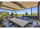 Elegant outdoor dining area with a large table, comfortable seating, and picturesque lake views, ideal for entertaining at 14480 Eagle Branch Dr, Nokomis, FL 34275